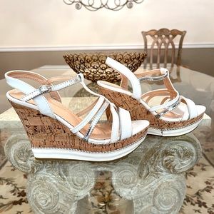 White/silver strap sandals with wedged cork platform heels with silver accent.